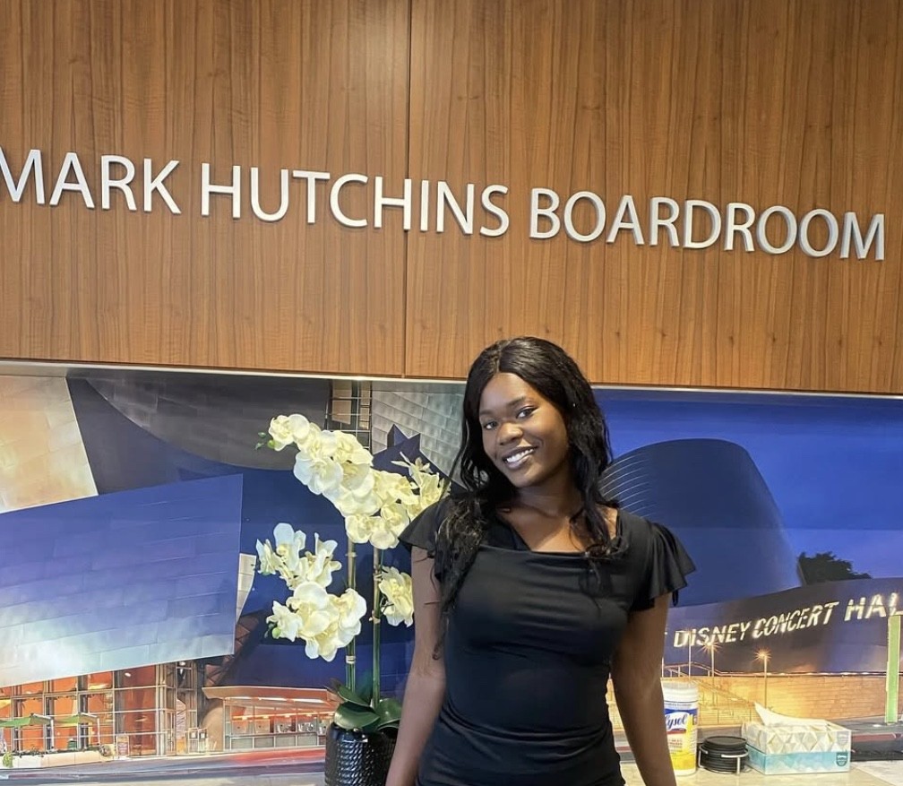 Eunice-Danielle Malingue smiling at the Mark Hutchins Boardroom